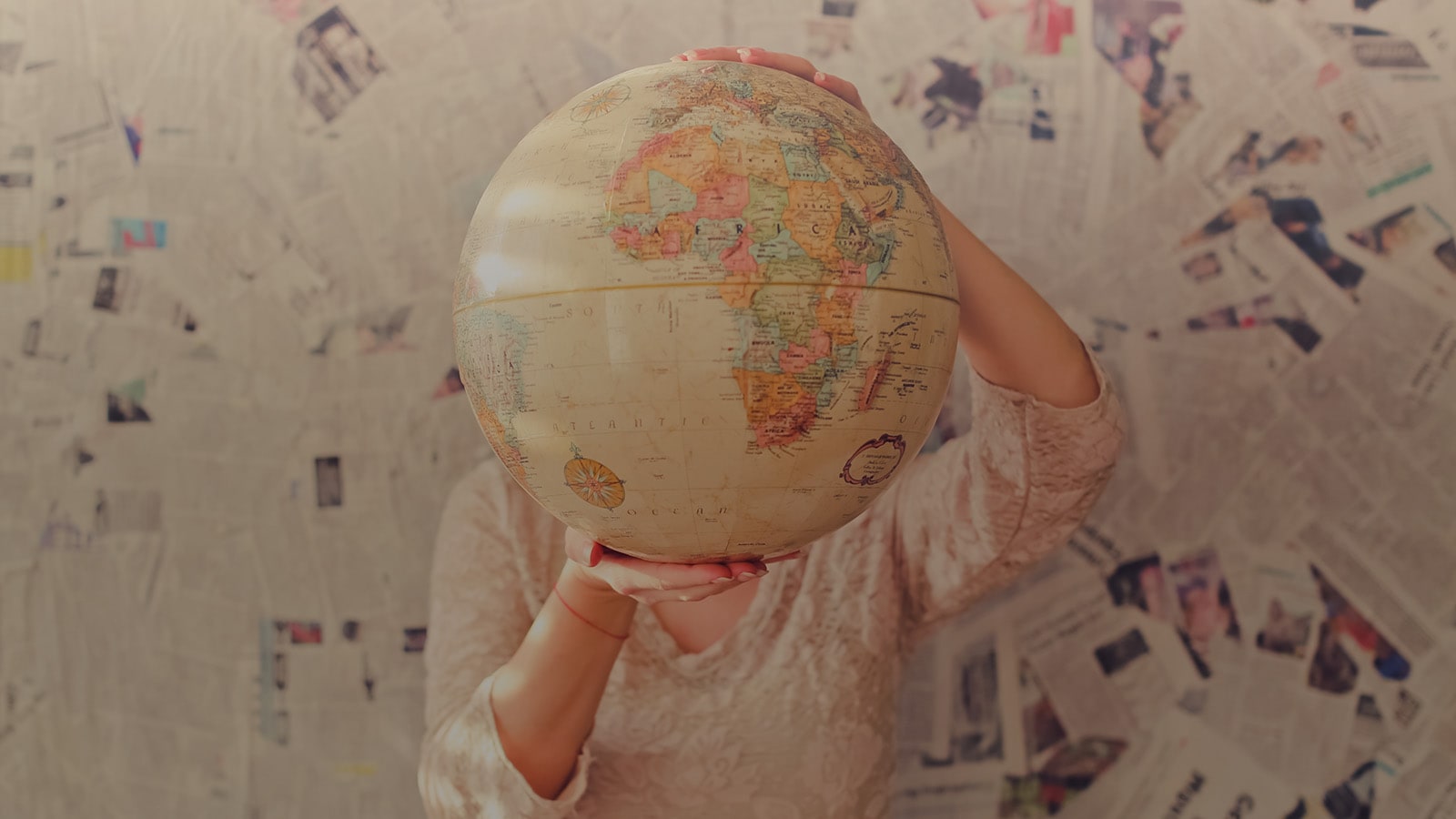 person holding world globe